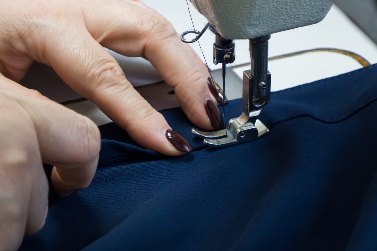 woman stitching by machine